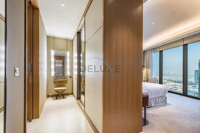 a bedroom with a bed and a view of a city at Elegant 3BR at The Address Residences Dubai Opera, Downtown Dubai by Deluxe Holiday Homes in Dubai