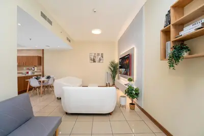 a living room with a couch and a table at Spacious Upgraded & Elegant - 1BR in Dubai