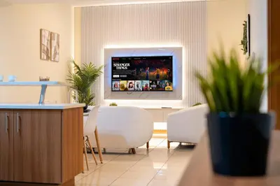 a living room with a tv on the wall at Spacious Upgraded & Elegant - 1BR in Dubai