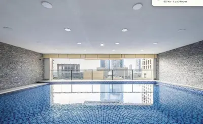 a swimming pool with a view of a building at Spacious Upgraded & Elegant - 1BR in Dubai