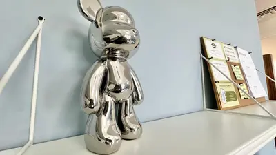 a silver sculpture of a dog on a shelf at Spacious Luxury Studio Near Mall of the Emirates with Pool Access in Dubai