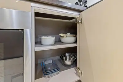 a kitchen with two bowls and a scale on a shelf at Spacious 1BR with Pool, Gym & Kids Play Area in Dubai