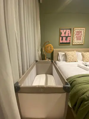 a room with a bed and a window with a bed frame at New Family Villa with PS5, Garden and Playroom in Dubai
