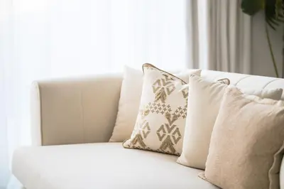 a white couch with pillows in a living room at New Family Villa with PS5, Garden and Playroom in Dubai