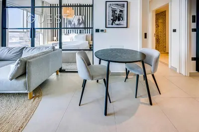 a living room with a table and chairs and a couch at Collective Tower, Dubai Hills Estate in Dubai