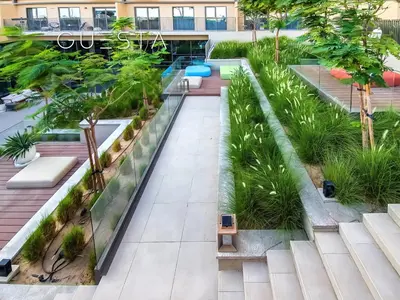 an overhead view of a courtyard in a building with trees at Collective Tower, Dubai Hills Estate in Dubai