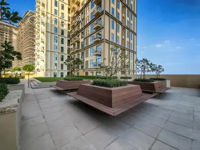 a row of benches in front of a tall building at Collective Tower, Dubai Hills Estate in Dubai