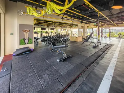 a gym with rows of treadmills and exercise bikes at Collective Tower, Dubai Hills Estate in Dubai