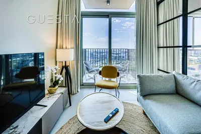 a living room with a couch and a table at Collective Tower, Dubai Hills Estate in Dubai