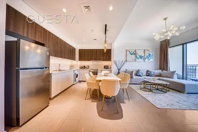 a kitchen and living room with a table and a couch at Park Heights 1 by Emaar, Dubai Hills Estate in Dubai