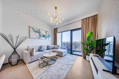 a living room with a couch and a tv at Park Heights 1 by Emaar, Dubai Hills Estate in Dubai