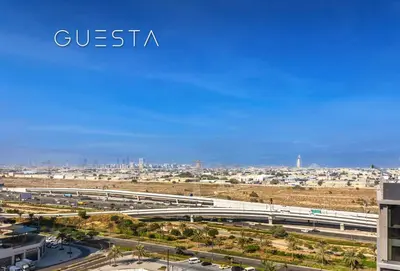 a view of a freeway with a city in the background at Park Heights 1 by Emaar, Dubai Hills Estate in Dubai