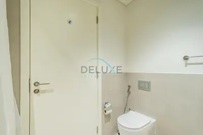 a bathroom with a white toilet and a shower at Bright 2BR in Surf at Creek Beach Building 1, Creek Harbour by Deluxe Holiday Homes in Dubai