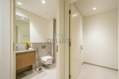 a bathroom with a toilet and a sink and a mirror at Bright 2BR in Surf at Creek Beach Building 1, Creek Harbour by Deluxe Holiday Homes in Dubai
