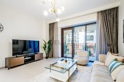 a living room with a couch and a tv at Bright 2BR in Surf at Creek Beach Building 1, Creek Harbour by Deluxe Holiday Homes in Dubai