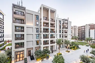 an aerial view of an apartment building with a courtyard at Bright 2BR in Surf at Creek Beach Building 1, Creek Harbour by Deluxe Holiday Homes in Dubai