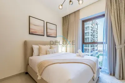 a bedroom with a large bed and a large window at Bright 2BR in Surf at Creek Beach Building 1, Creek Harbour by Deluxe Holiday Homes in Dubai