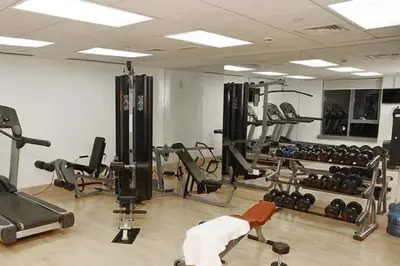 a gym with a lot of equipment in a room at Vacay lettings 1 bed close to down town Fountain View in Dubai