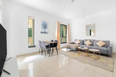 a living room with a couch and a table at Vacay lettings 1 bed close to down town Fountain View in Dubai
