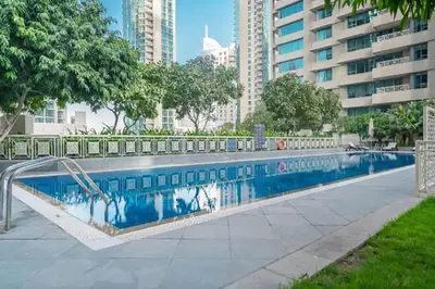 a swimming pool in the middle of a city at Vacay lettings 1 bed close to down town Fountain View in Dubai