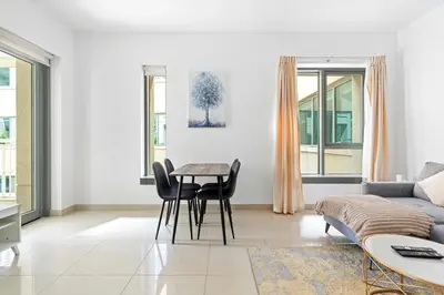 a living room with a couch and a table at Vacay lettings 1 bed close to down town Fountain View in Dubai
