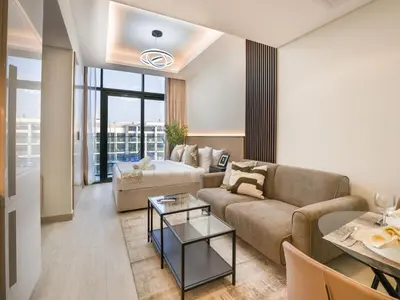 a living room with a couch and a table at EasyGo - Bright and Airy Studio in Azizi Riviera 9 in Dubai