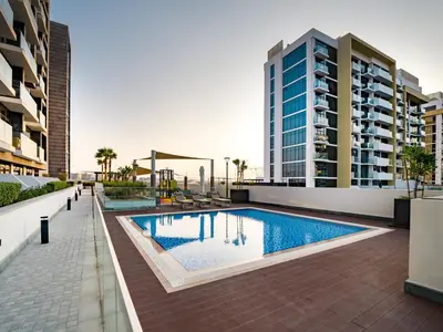 a swimming pool on the roof of a building at EasyGo - Bright and Airy Studio in Azizi Riviera 9 in Dubai