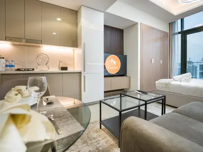 a living room with a couch and a table at EasyGo - Bright and Airy Studio in Azizi Riviera 9 in Dubai