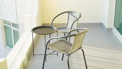 two chairs and a table on a balcony at 2 Bedroom beach front apartment in Dubai