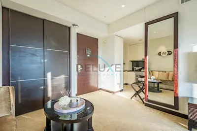 a living room with a table and a mirror at Lovely Studio in The Address Residence Dubai Marina by Deluxe Holiday Homes in Dubai