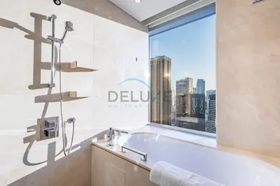 a bathroom with a bath tub and a window at Lovely Studio in The Address Residence Dubai Marina by Deluxe Holiday Homes in Dubai