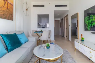 a living room with a couch and a table at Casa Azure in Dubai