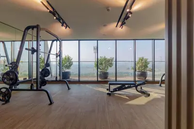 a gym with a large window and two tread machines at Casa Azure in Dubai