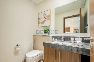 a bathroom with a toilet and a sink at Sea View 3BR with Assistant Room and Balcony, Just Steps from Marina Promenade, 5242 Tower 1, Dubai Marina by Deluxe Holiday Homes in Dubai