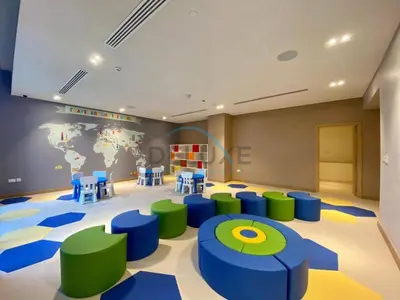 a room with blue and green chairs and a world map at Sea View 3BR with Assistant Room and Balcony, Just Steps from Marina Promenade, 5242 Tower 1, Dubai Marina by Deluxe Holiday Homes in Dubai