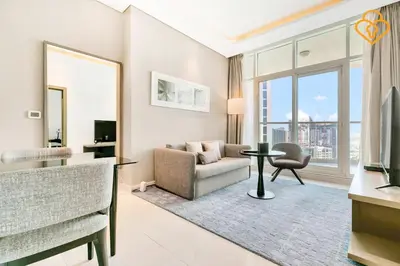 a living room with a couch and a chair and a television at Keysplease 1BR Apartment Damac Maison Prive Business Bay in Dubai