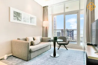 a living room with a couch and a table at Keysplease 1BR Apartment Damac Maison Prive Business Bay in Dubai