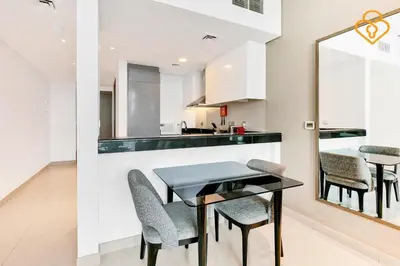a kitchen and dining room with a table and chairs at Keysplease 1BR Apartment Damac Maison Prive Business Bay in Dubai