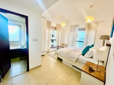 a bedroom with a large bed and a window at One bedroom apartment available in Front of Marina Beach Dubai in Dubai