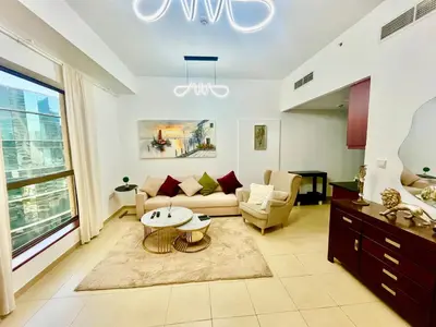a living room with a couch and a table at One bedroom apartment available in Front of Marina Beach Dubai in Dubai
