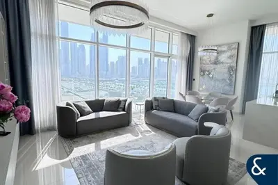 a living room with couches and a large window at Dubai Harbour in Dubai
