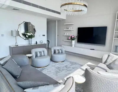 a living room with a couch and two chairs and a tv at Dubai Harbour in Dubai