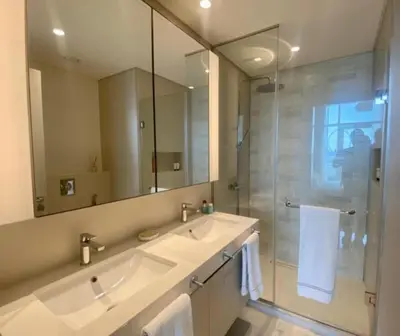 a bathroom with a sink and a shower with a mirror at Dubai Harbour in Dubai