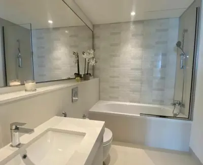 a bathroom with a tub and a toilet and a sink at Dubai Harbour in Dubai