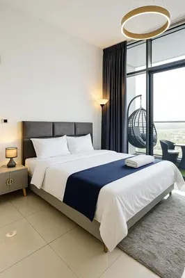 a bedroom with a large bed and a large window at Dezire Delight in Dubai
