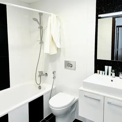a white bathroom with a toilet and a sink at Dezire Delight in Dubai