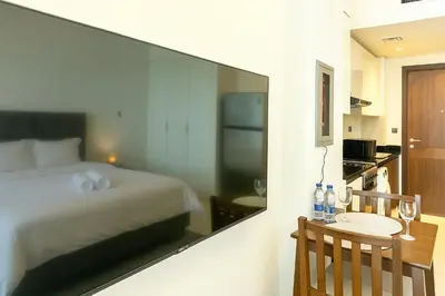 a bedroom with a bed and a table with wine glasses at Dezire Delight in Dubai