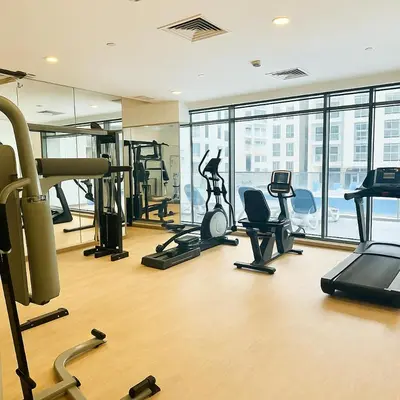 a gym with treadmills and exercise equipment in a building at Dezire Delight in Dubai