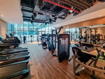 a gym with treadmills and exercise equipment in a building at Apartment on Palm Jumeirah Beach Parking in Dubai