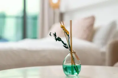 a glass vase with flowers in it on a table at Apartment on Palm Jumeirah Beach Parking in Dubai